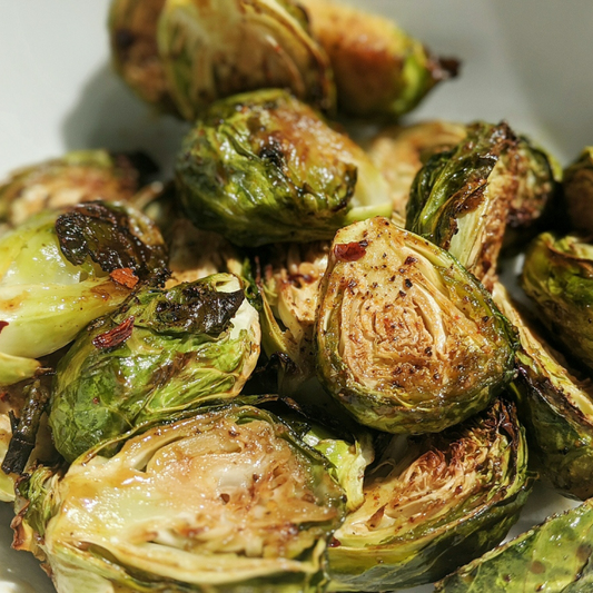 Brussel sprouts that have been baked. The edges of the sprouts are wilted and darkened.